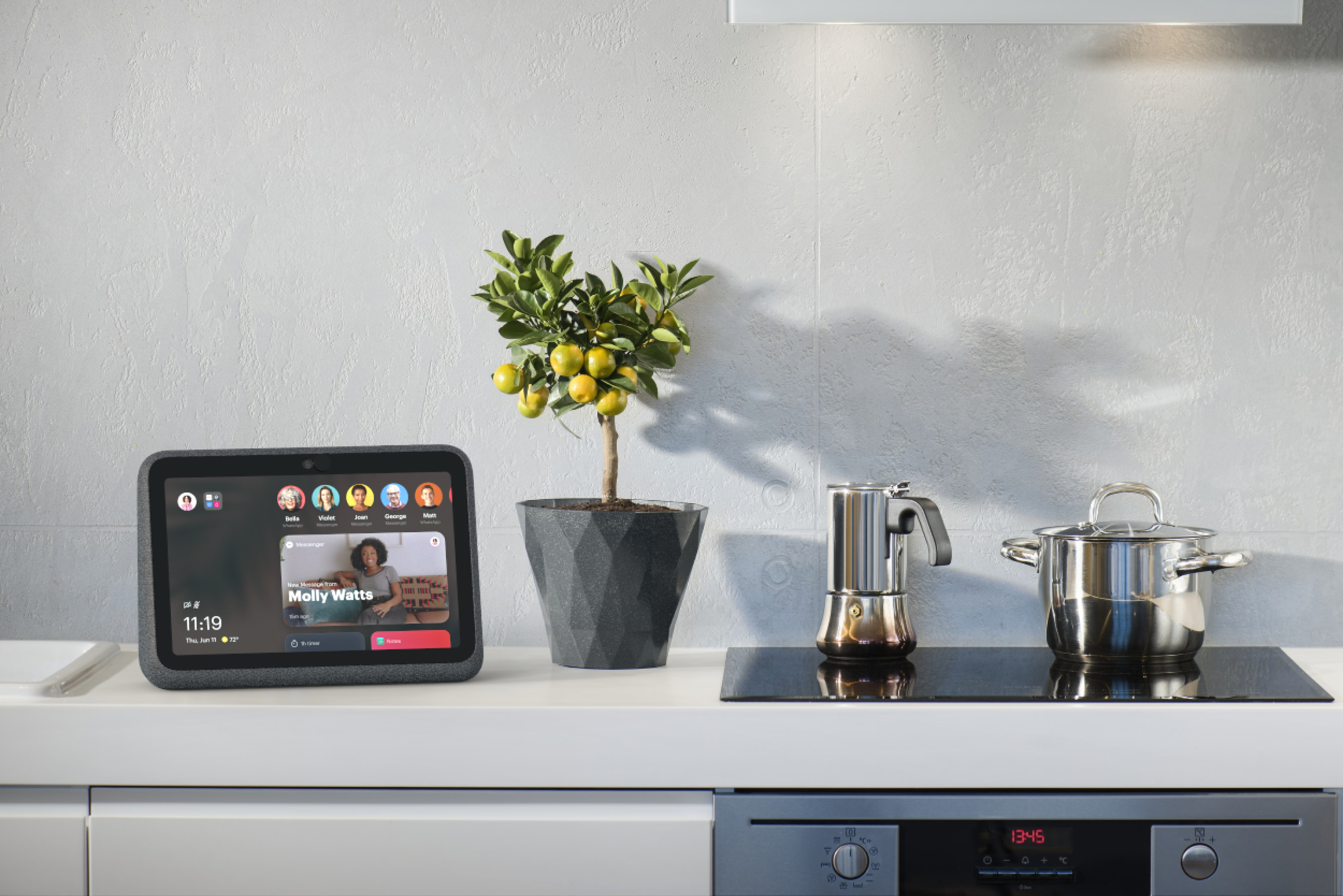 Meta Portal on a kitchen counter beside a citrus tree